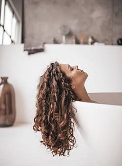 Девушка с красивыми волосами в ванной